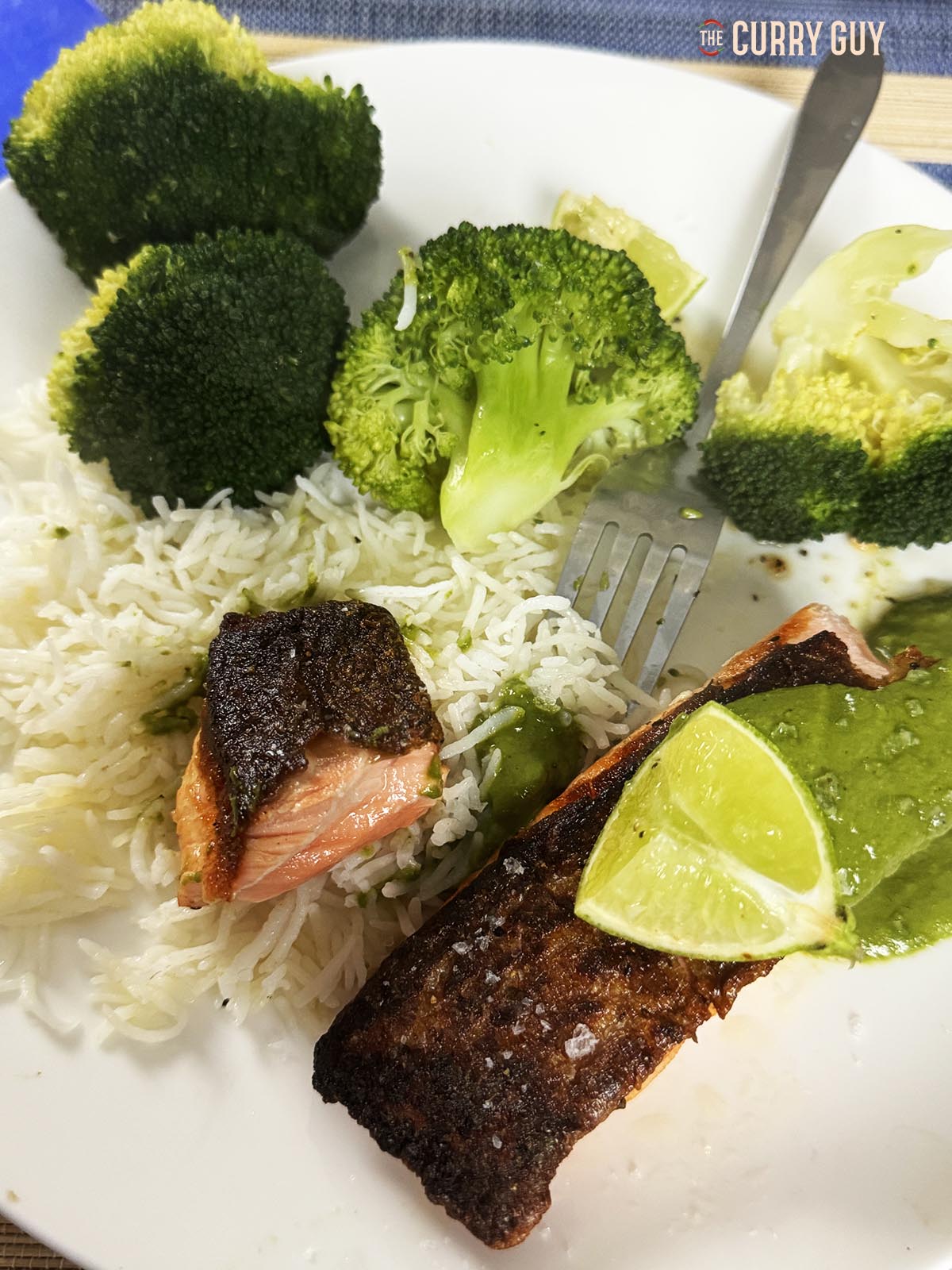 the crispy skin salmon on a serving plate with rice and vegetables.