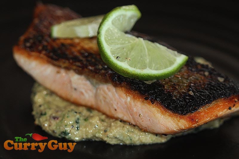 salmon on top of coriander and cashew sauce prepared in a pestle and mortar