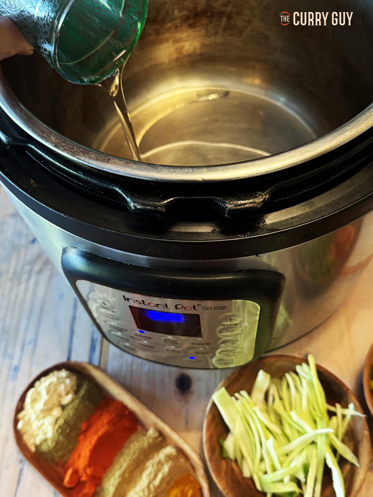 Pouring oil into a multi cooker.