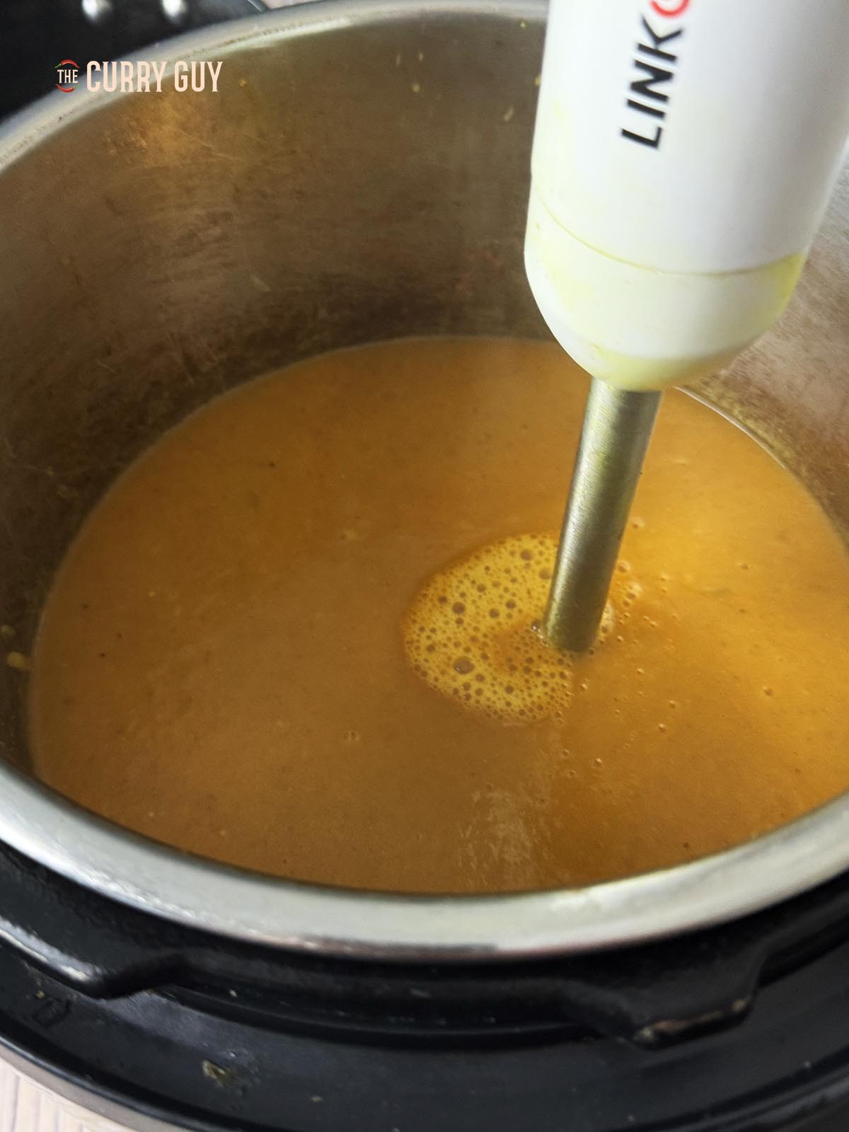 Blending the base sauce until smooth.