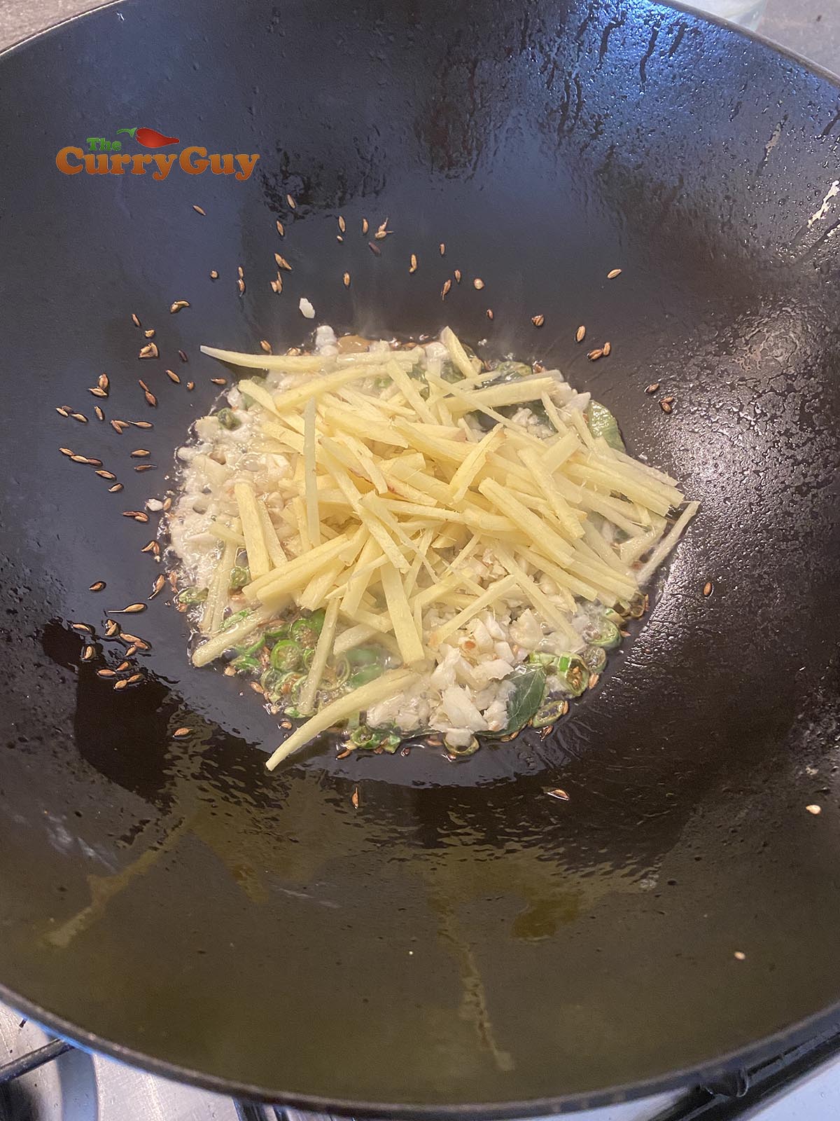 adding ginger to pan