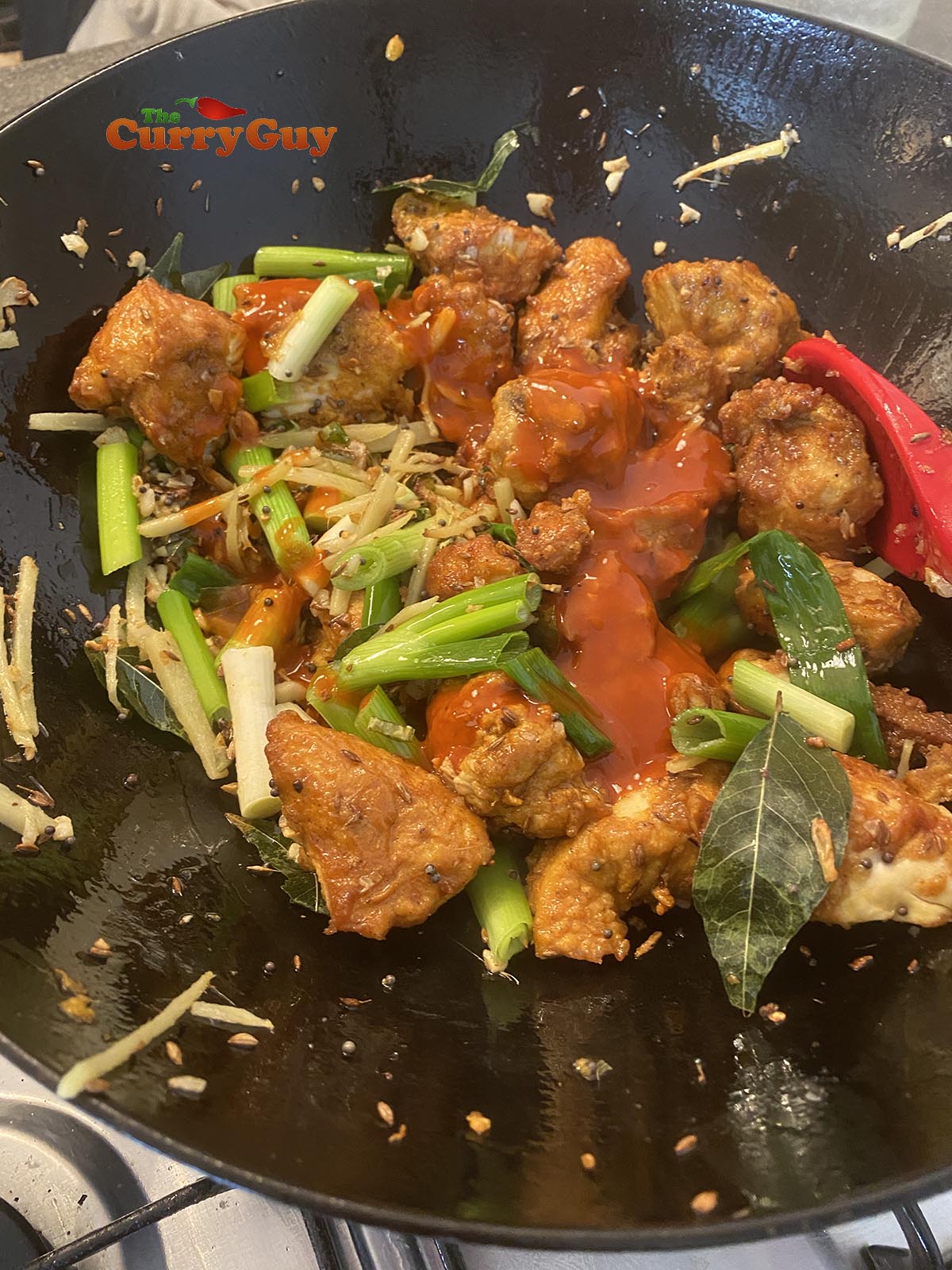 Adding hot sauce to pan.