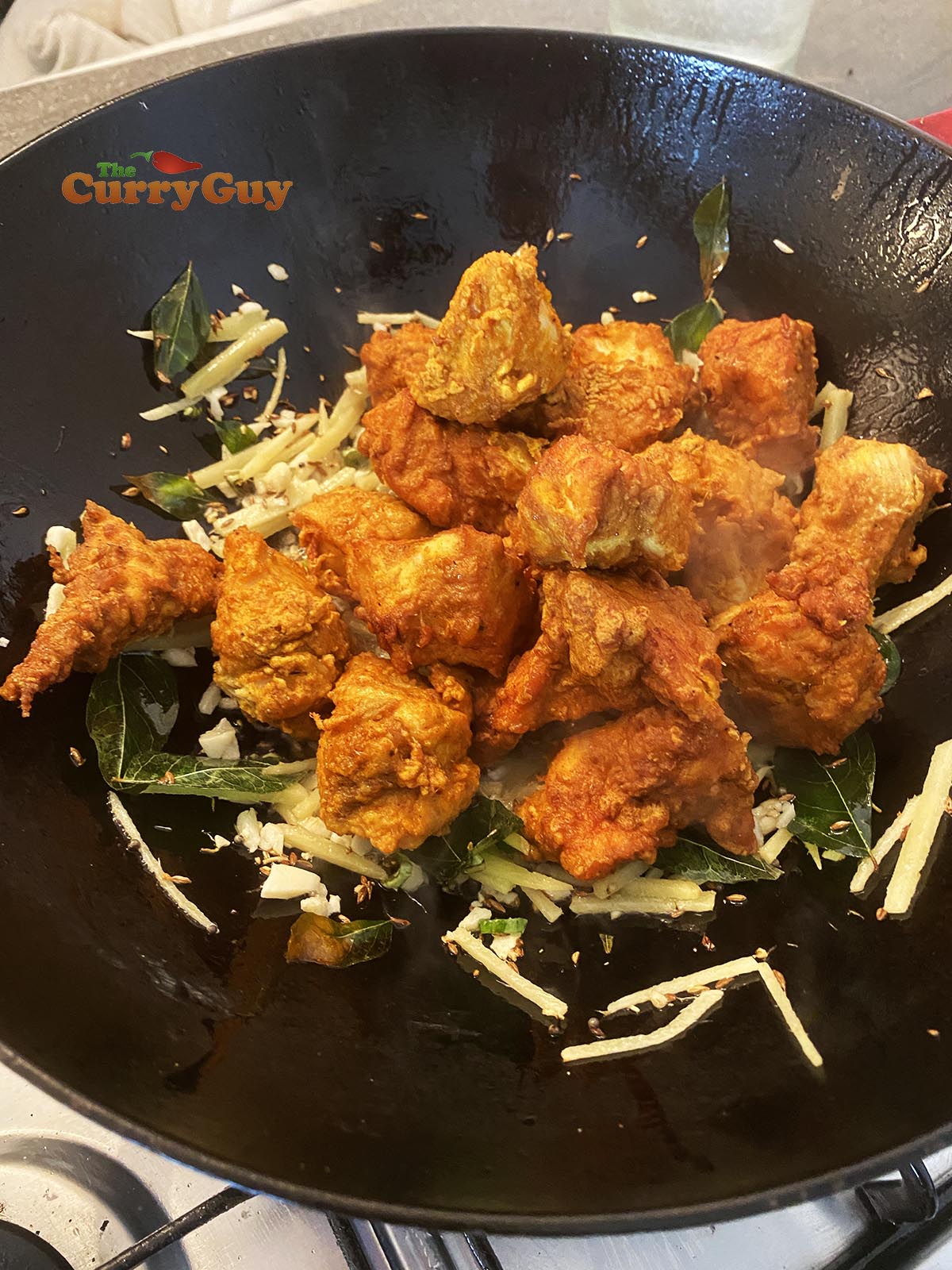 adding chicken to the pan.