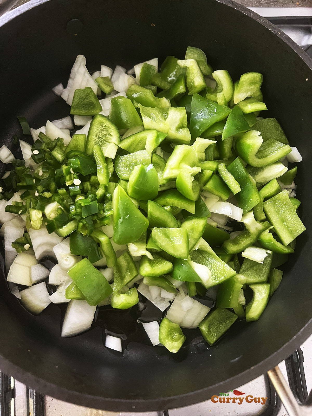 Frying the bell peppers, onions and chillies.