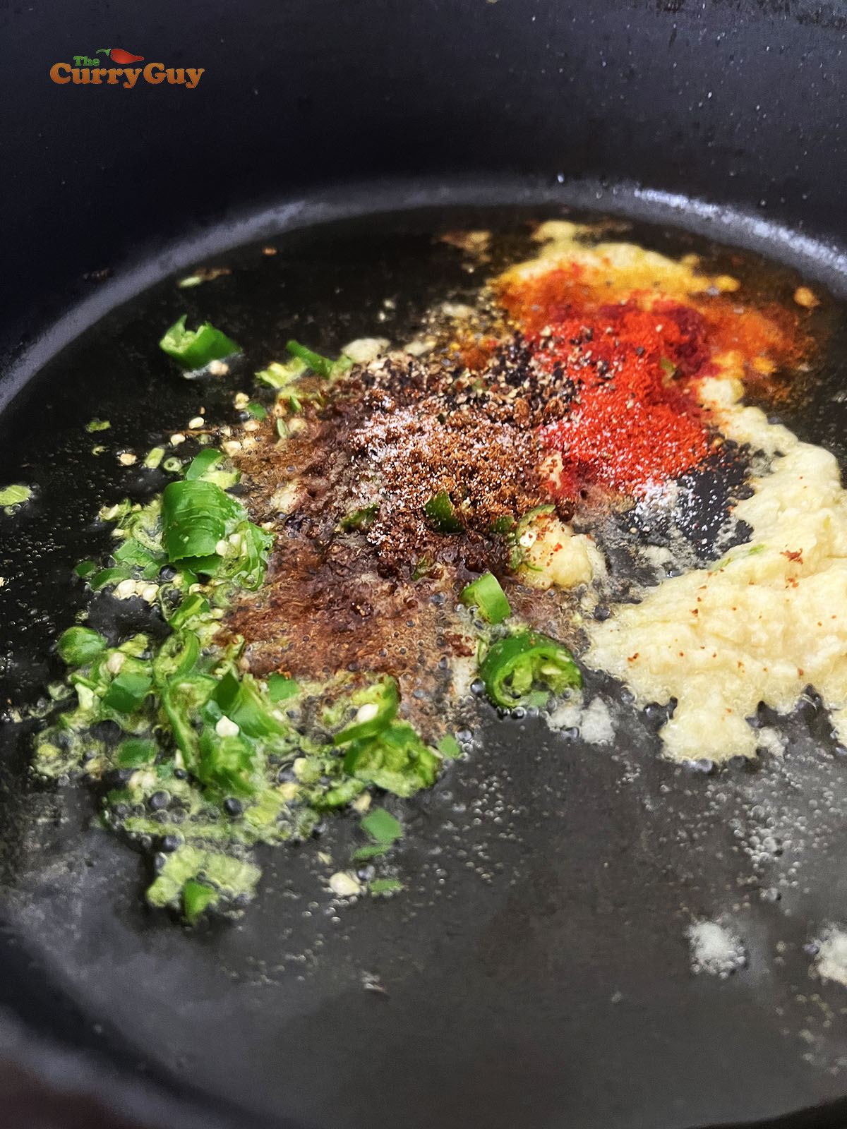 Adding chilli powder and chaat masala to the pan