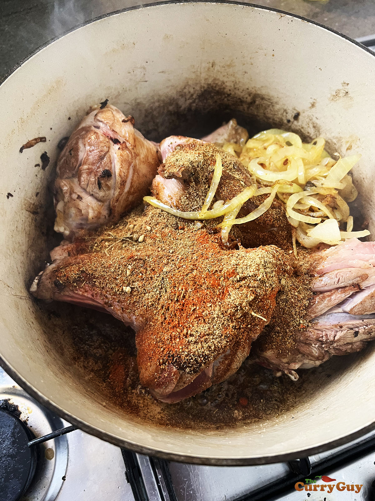 Adding fried onions and the spice blends to the meat.