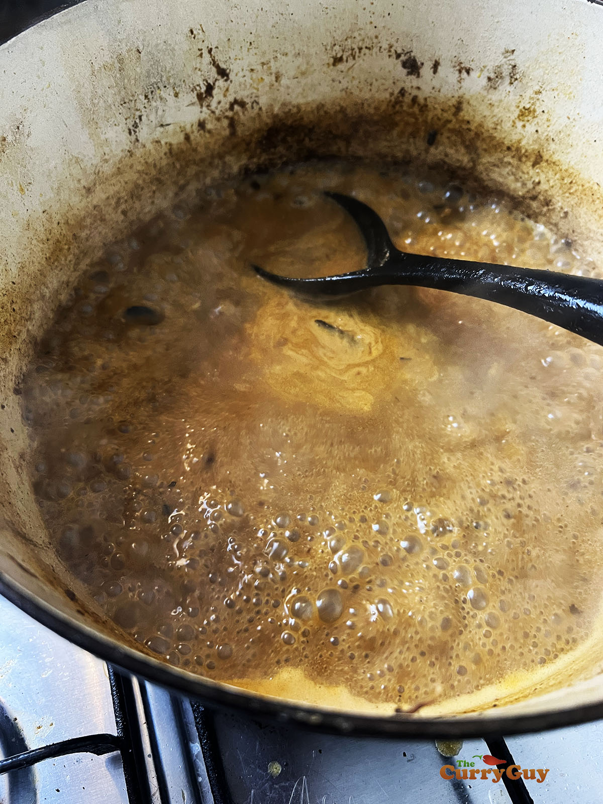 Adding flour to the sauce to thicken.
