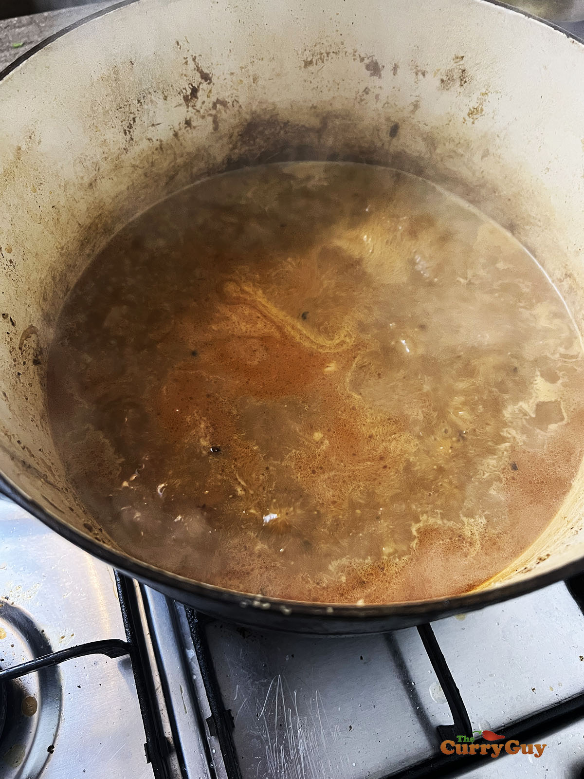Simmering the sauce without the lamb shanks.