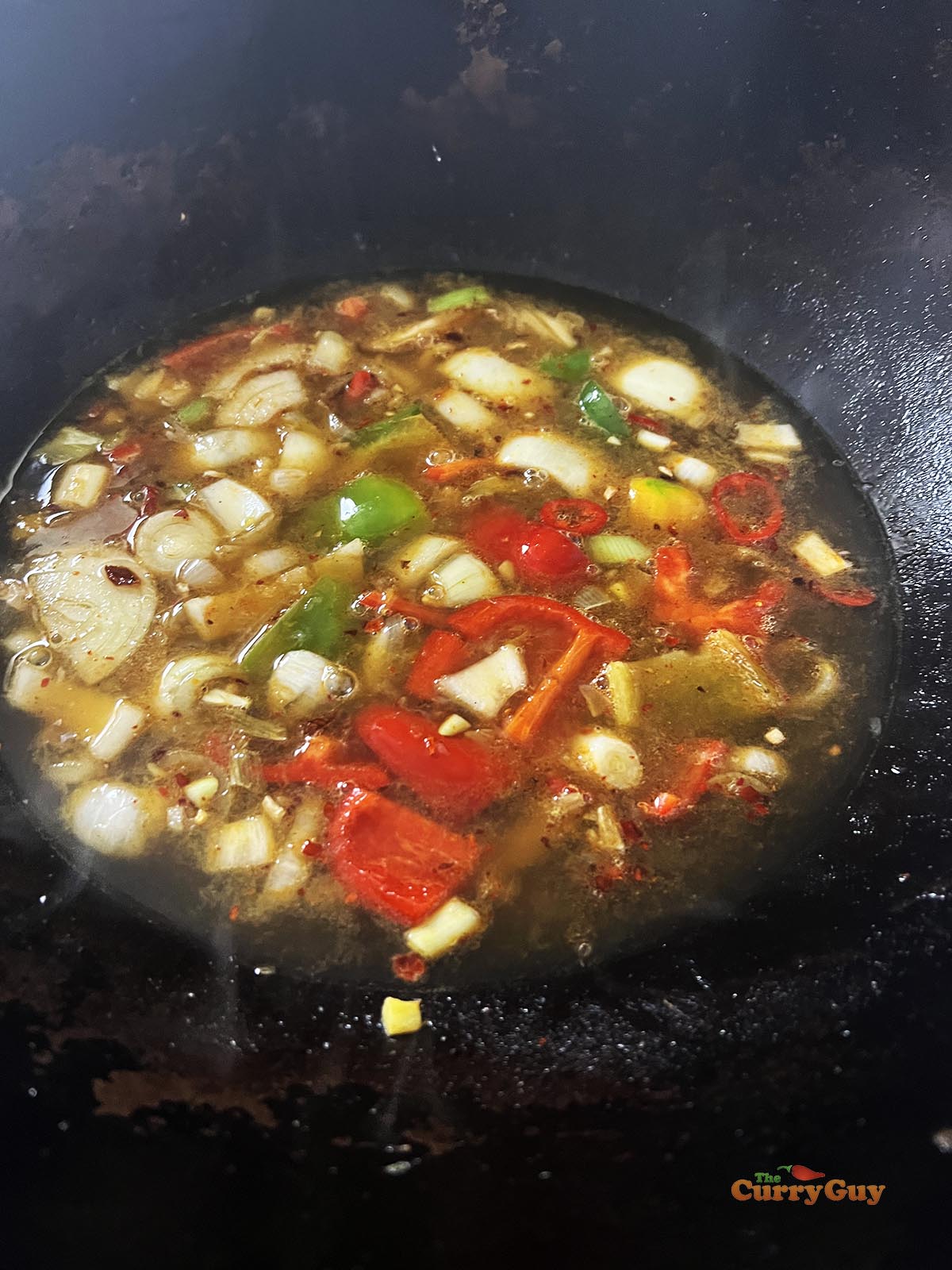 Stirring in the prepared sweet and sour sauce.