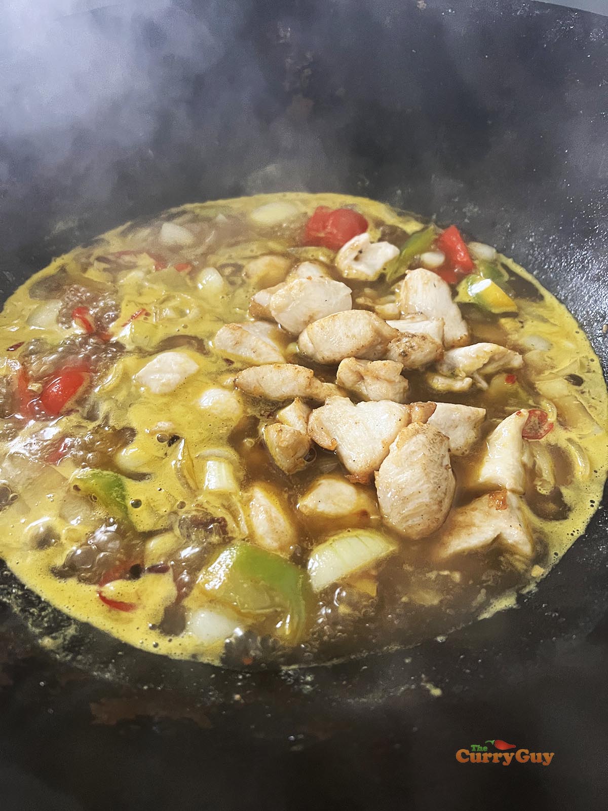 Adding the fried chicken to the sauce.