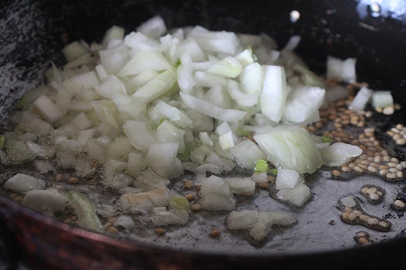Adding onions to the pan