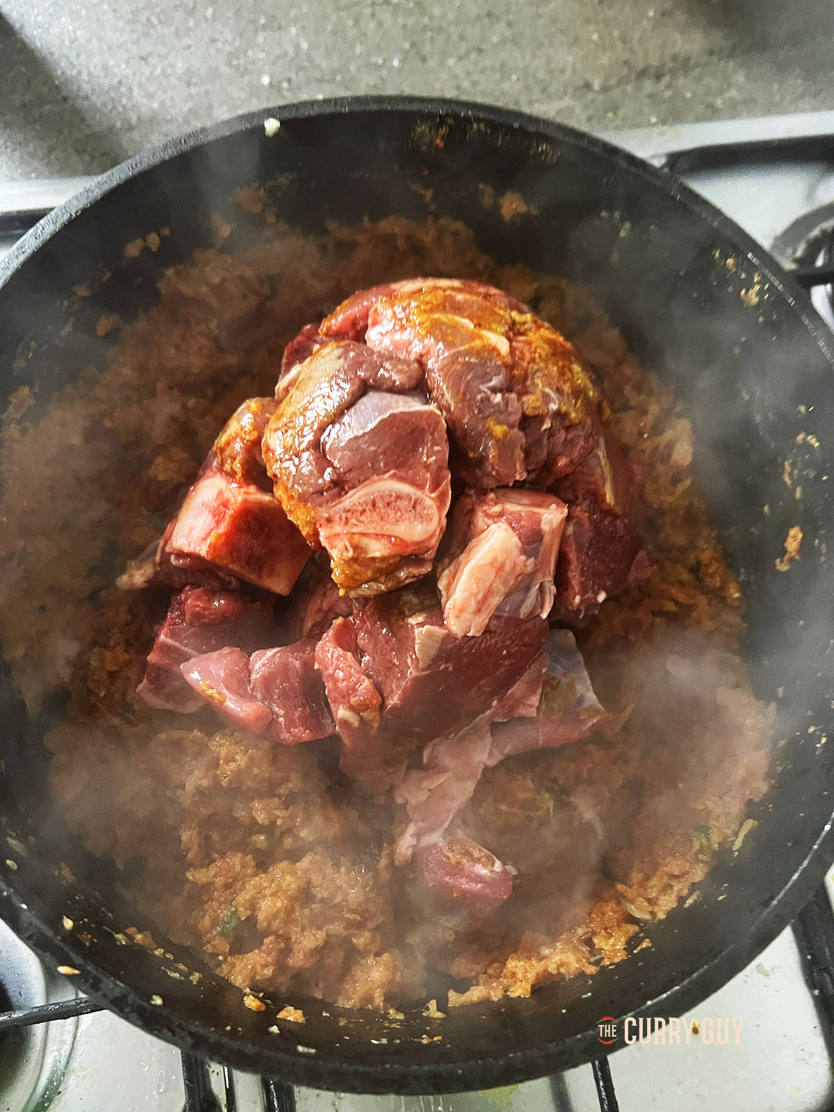 Adding the meat to the pan.