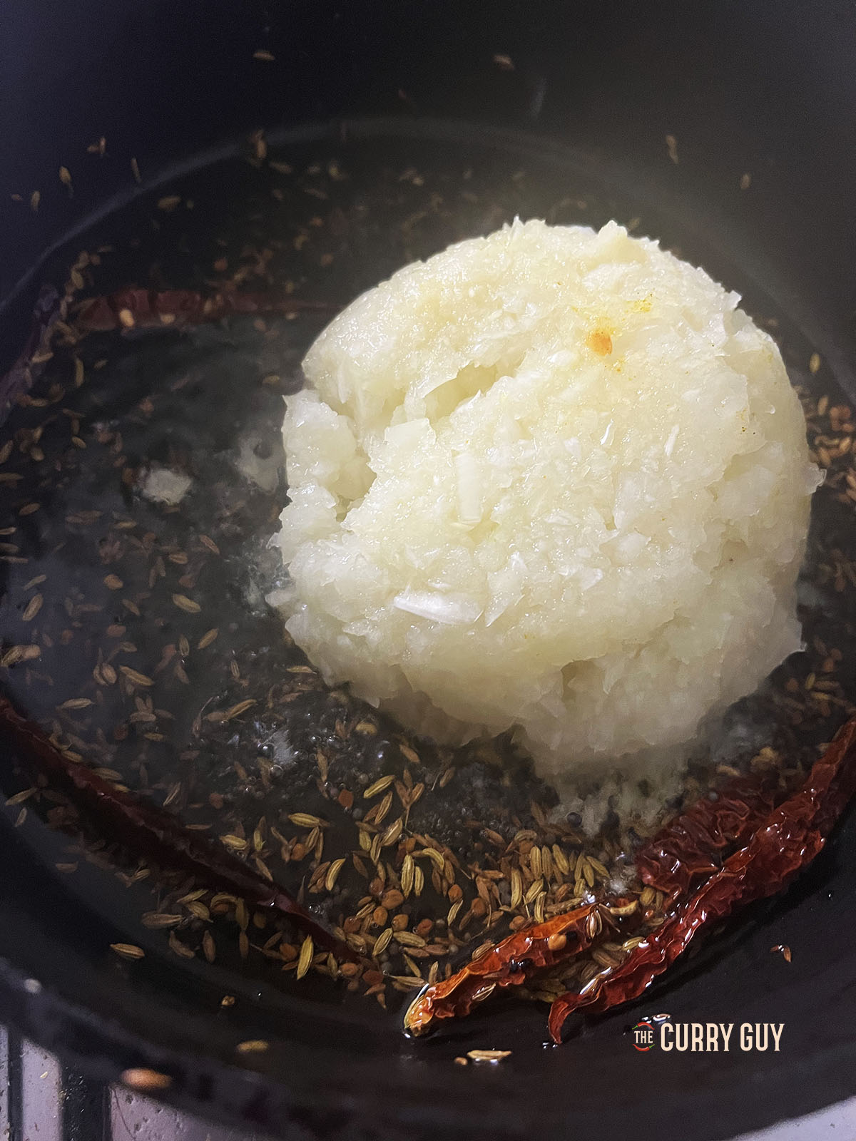 Adding the chopped onions to the pan.