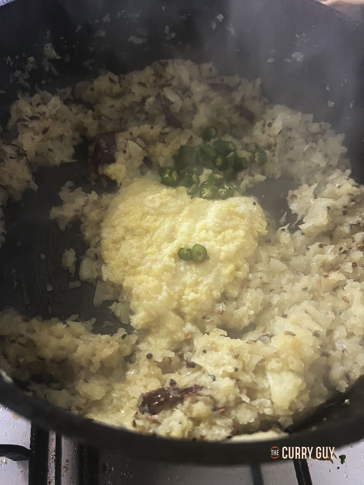 Adding the garlic and ginger paste and the chopped chillies to the pan.