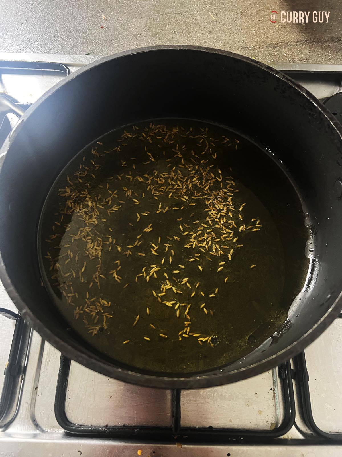 Tempering cumin seeds in ghee.