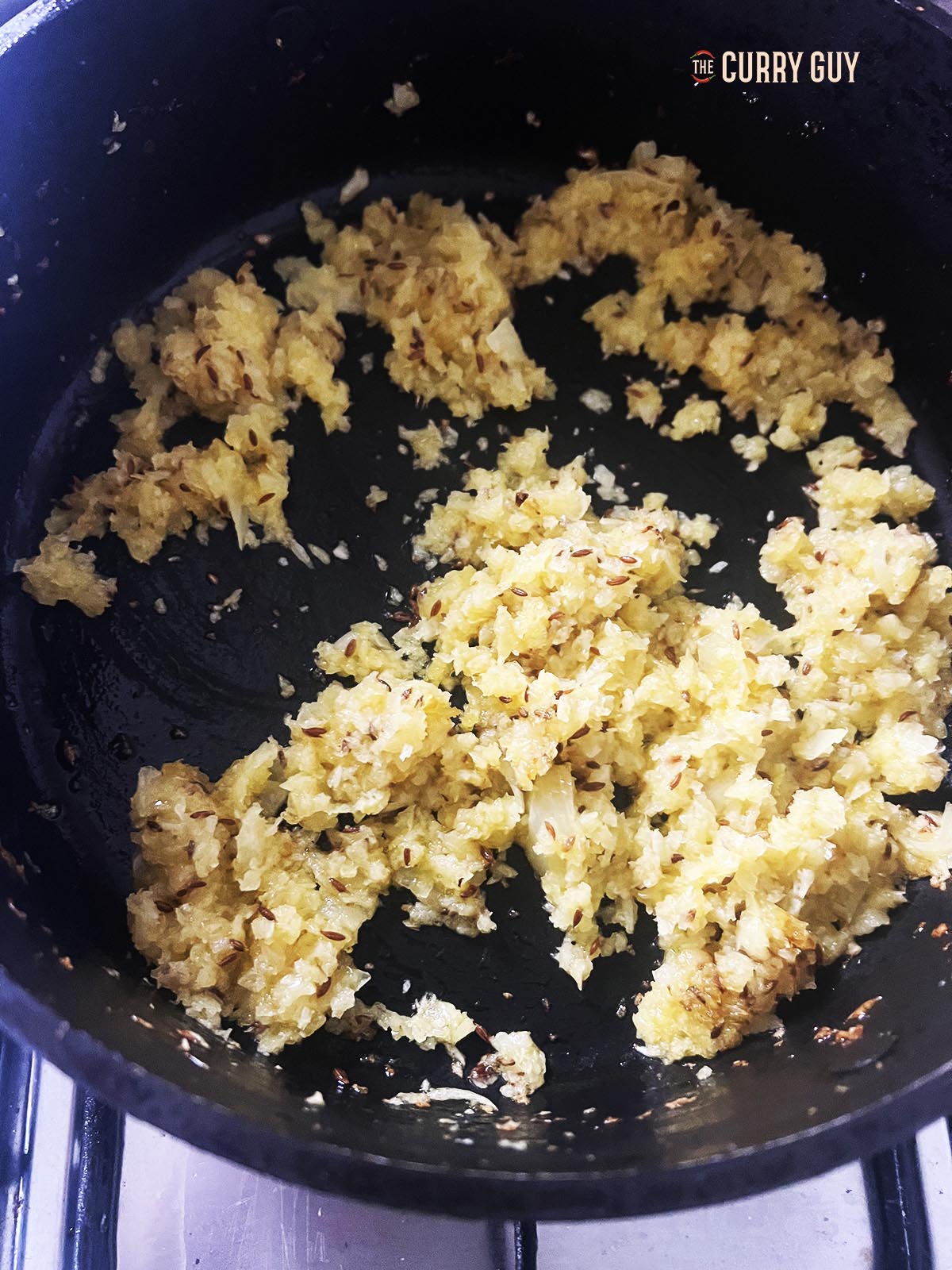 Adding the onions to the pan.