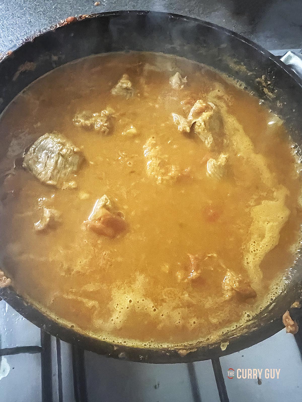 Simmering the meat and potatoes. 