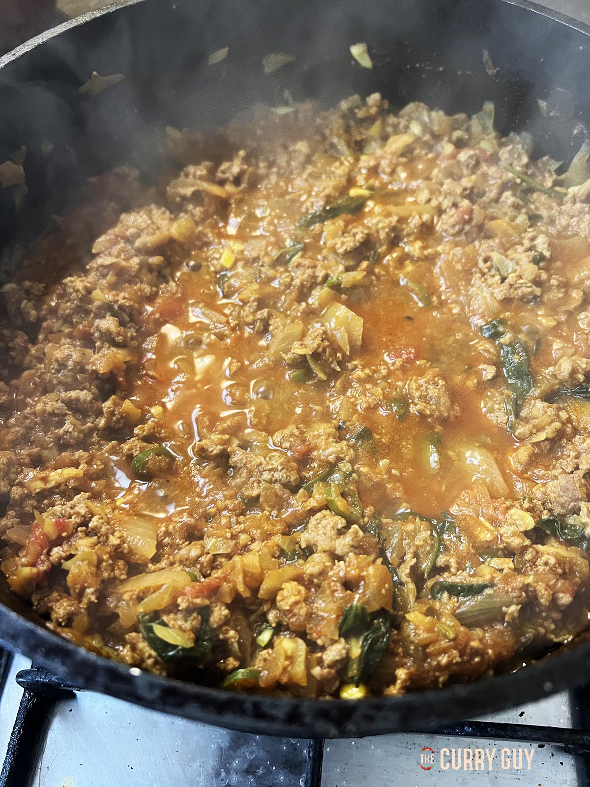 Simmering the meat in the pan.