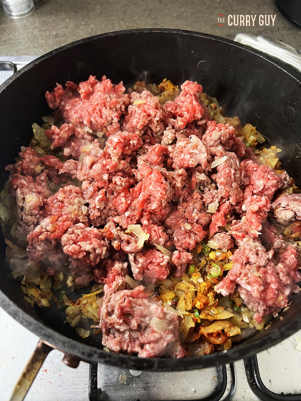 Adding the beef to the biryani.