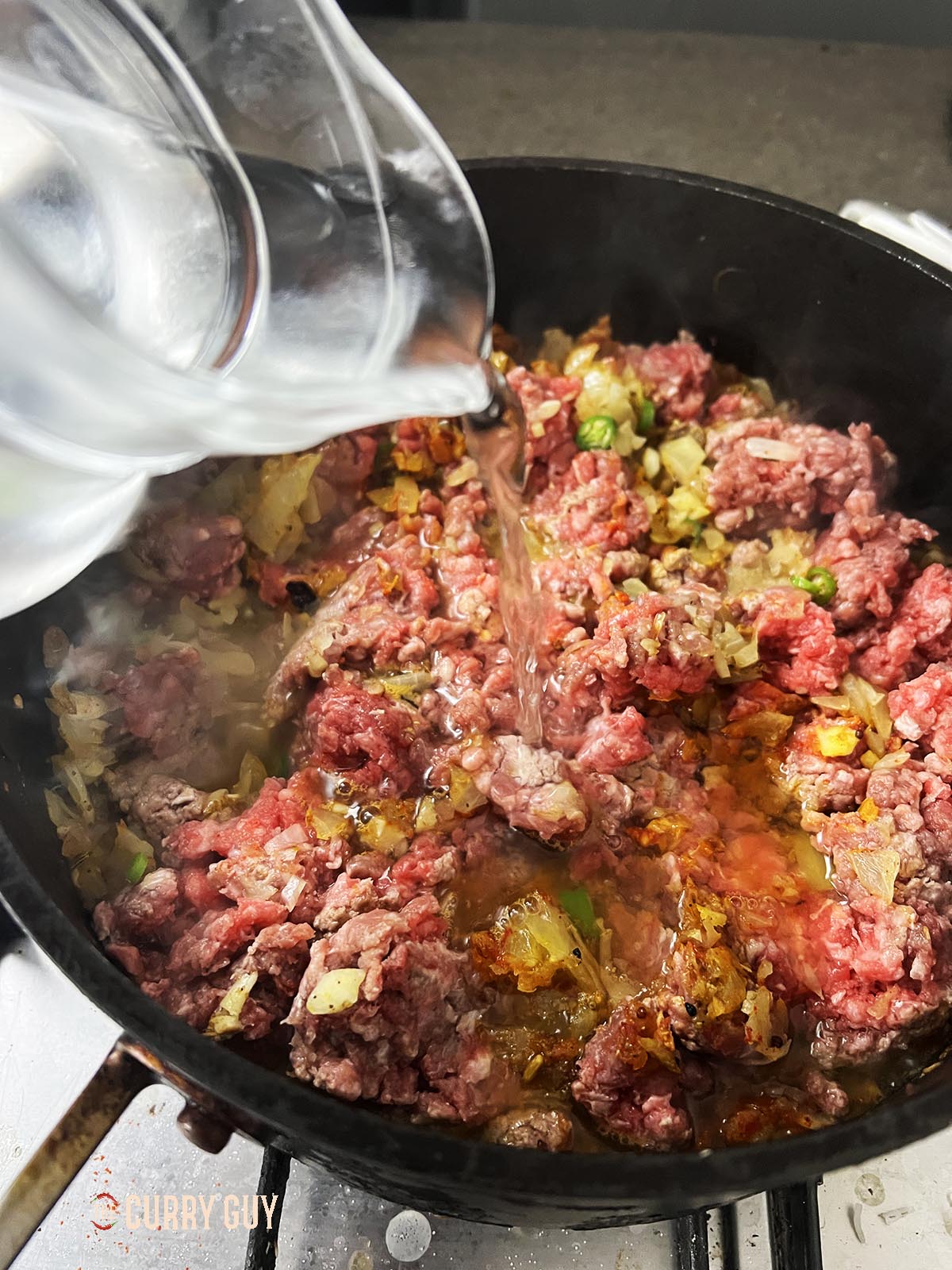 Adding water to the pan.