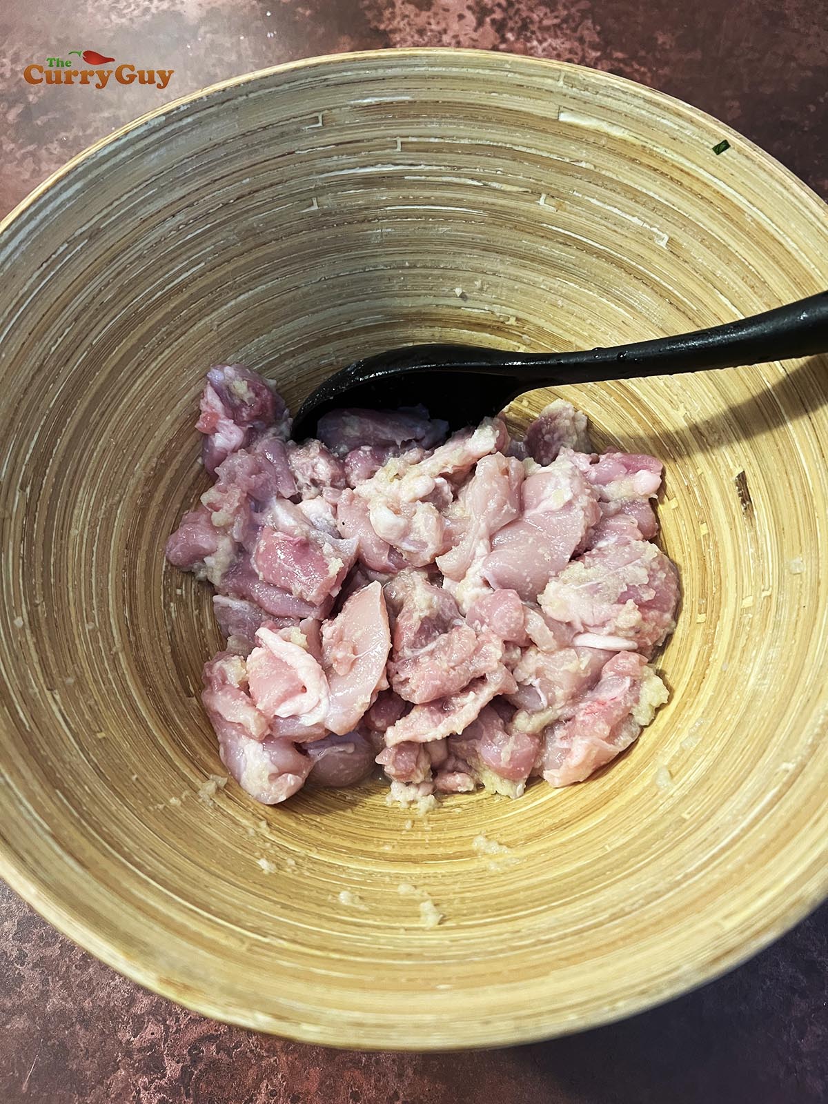 Marinating the chicken in lemon juice, garlic and ginger and salt