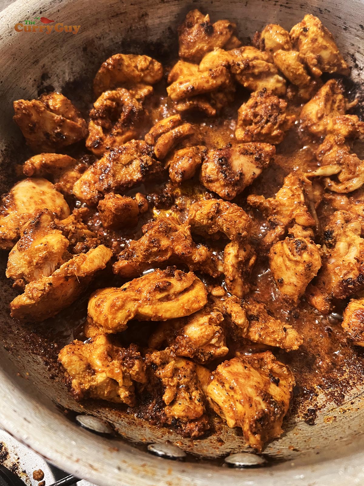 Frying chicken tikka after smoking.