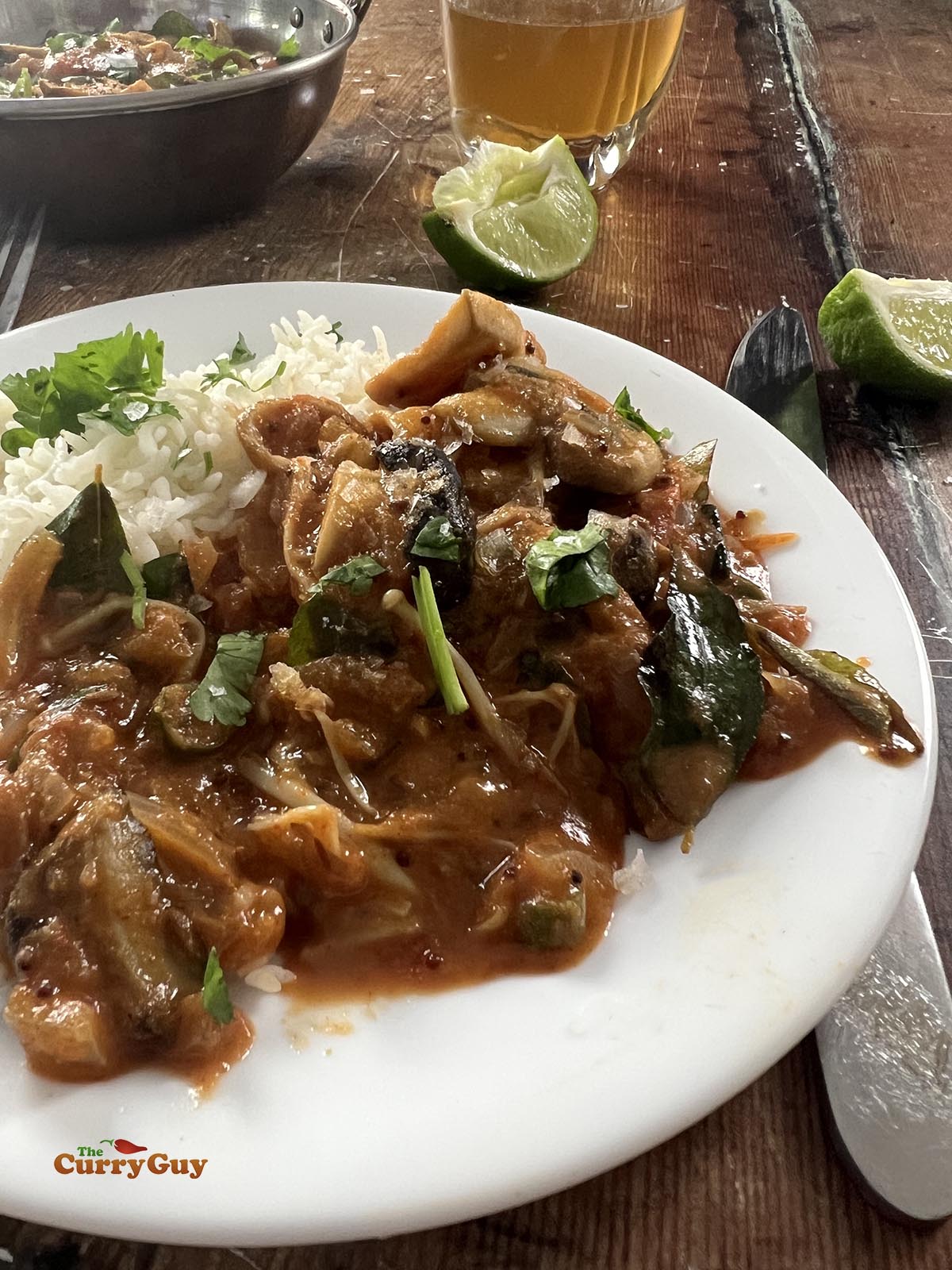 Garnishing the mushroom curry with chopped coriander (cilantro). 