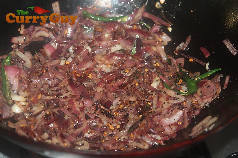 Frying the onions until they are soft and translucent