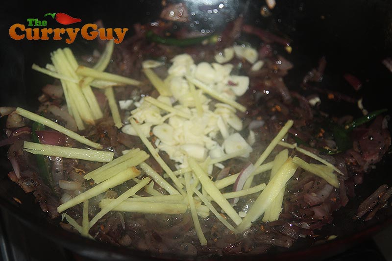 Stirring in the garlic and ginger to make a base masala.
