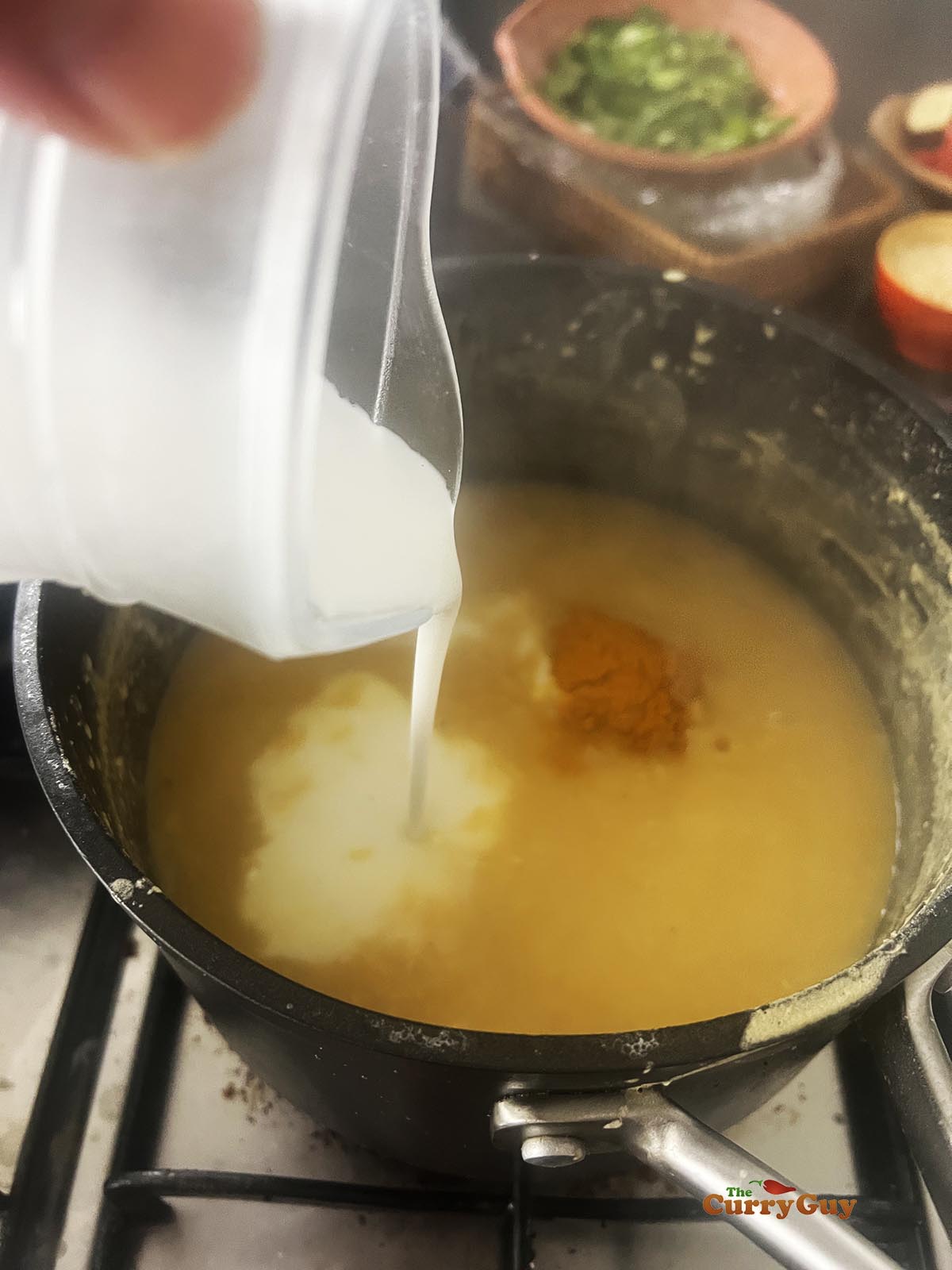 Adding the coconut milk and chili powder.