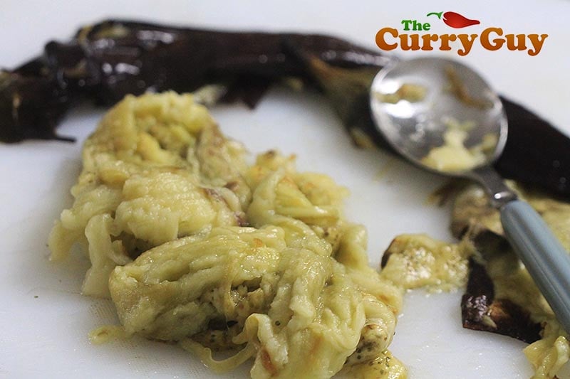 Making aubergine balti