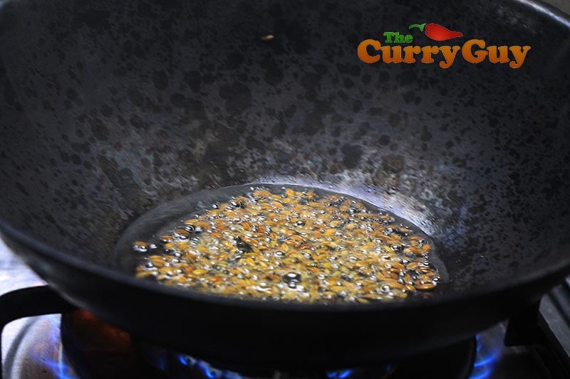 Making aubergine balti