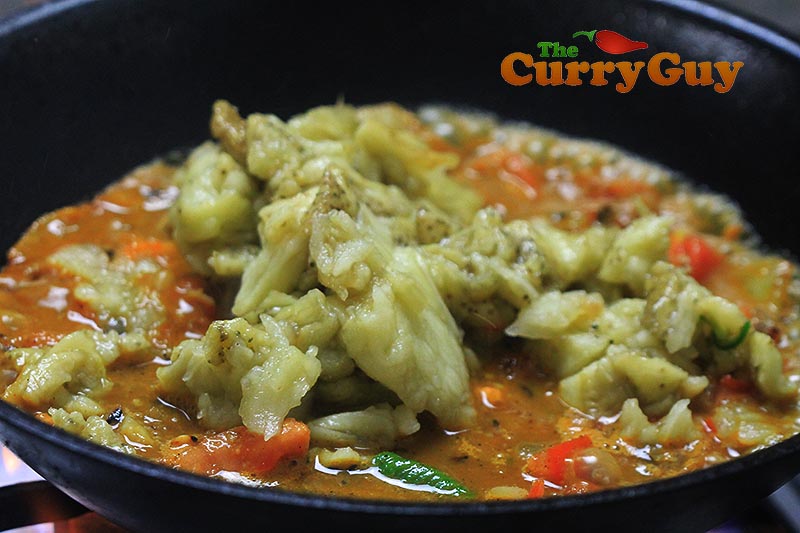 Making aubergine balti