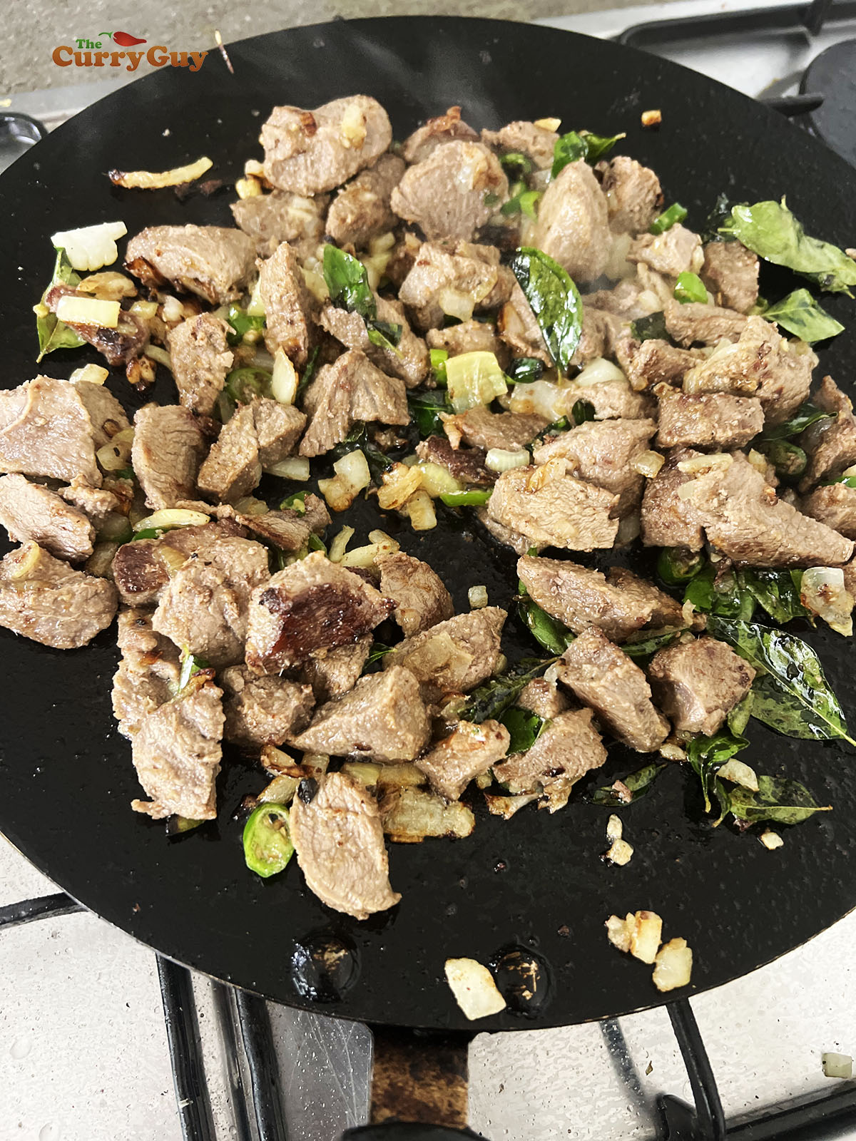 Adding lamb to the pan