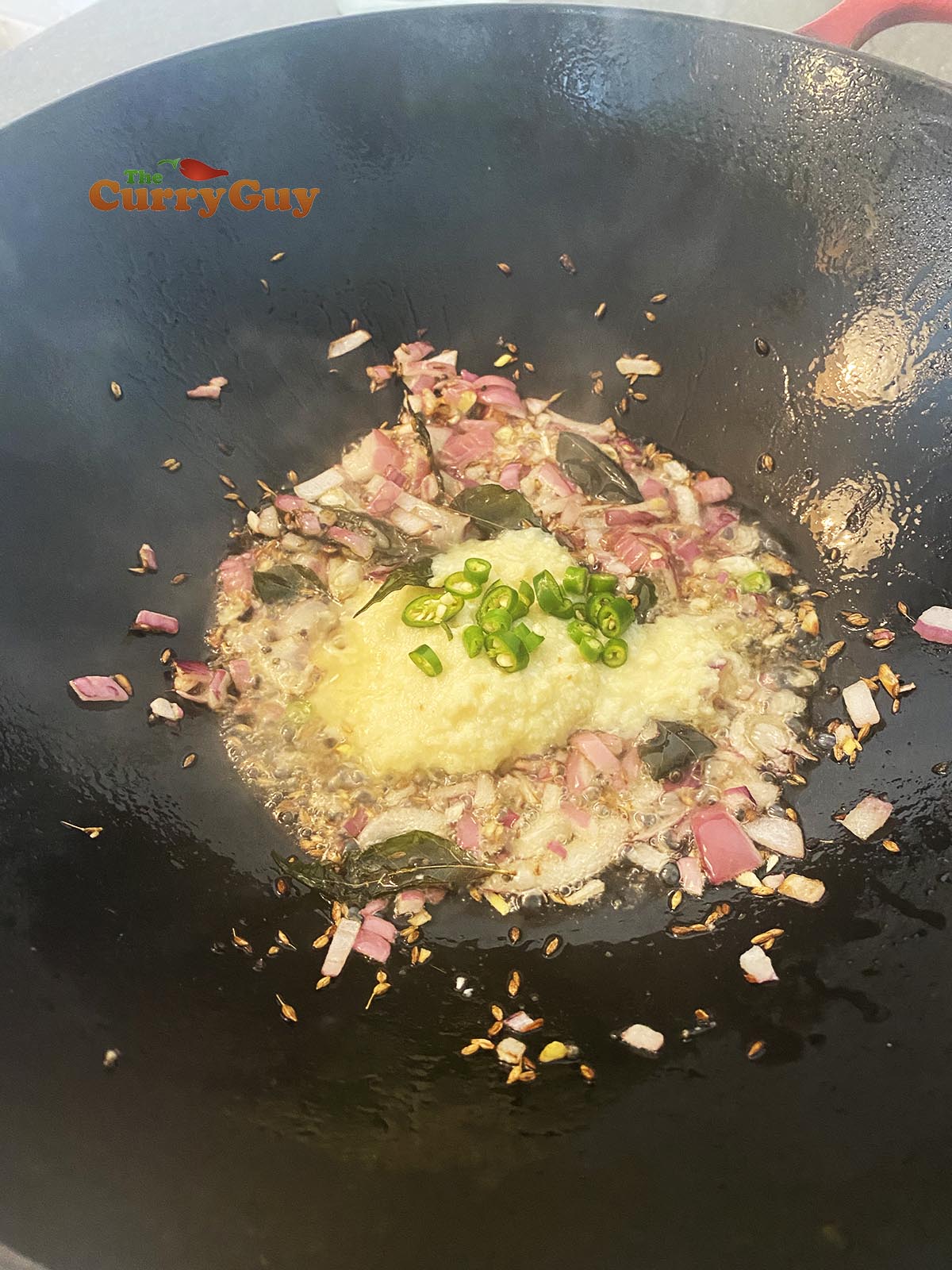 adding garlic, ginger and chillies to the pan