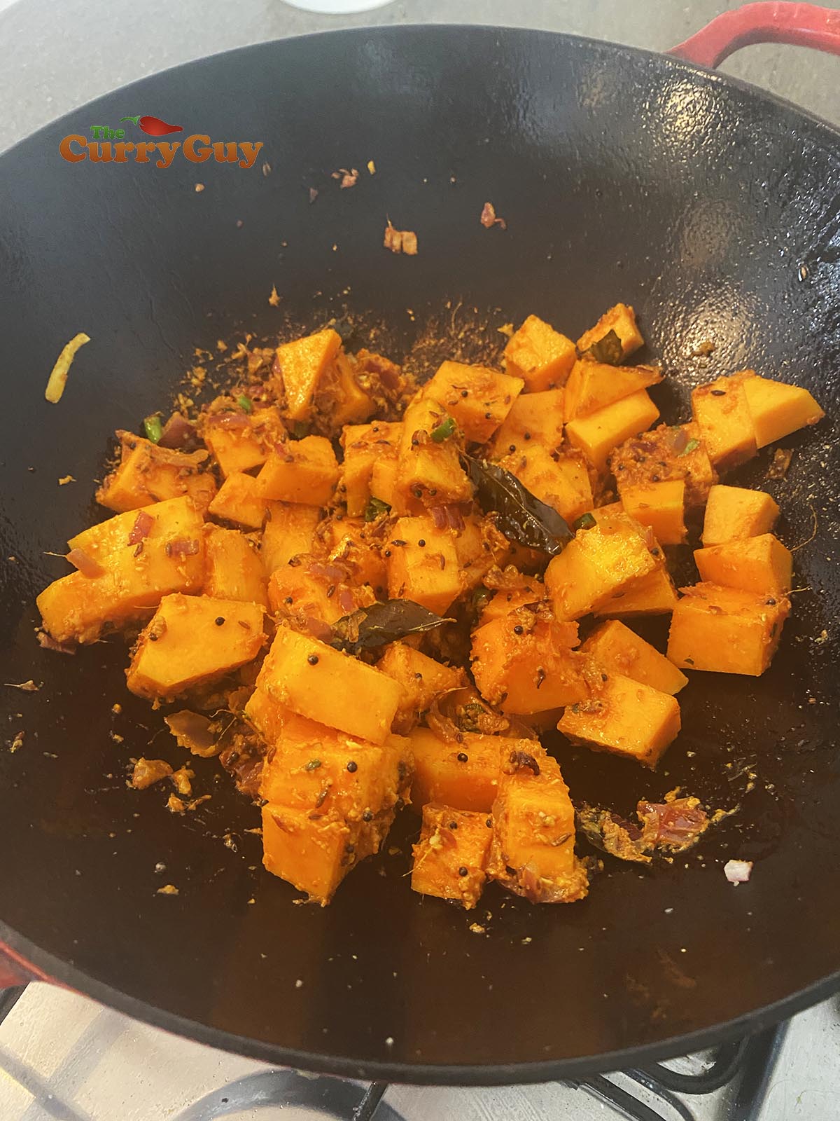 Adding butternut squash to the butternut squash curry