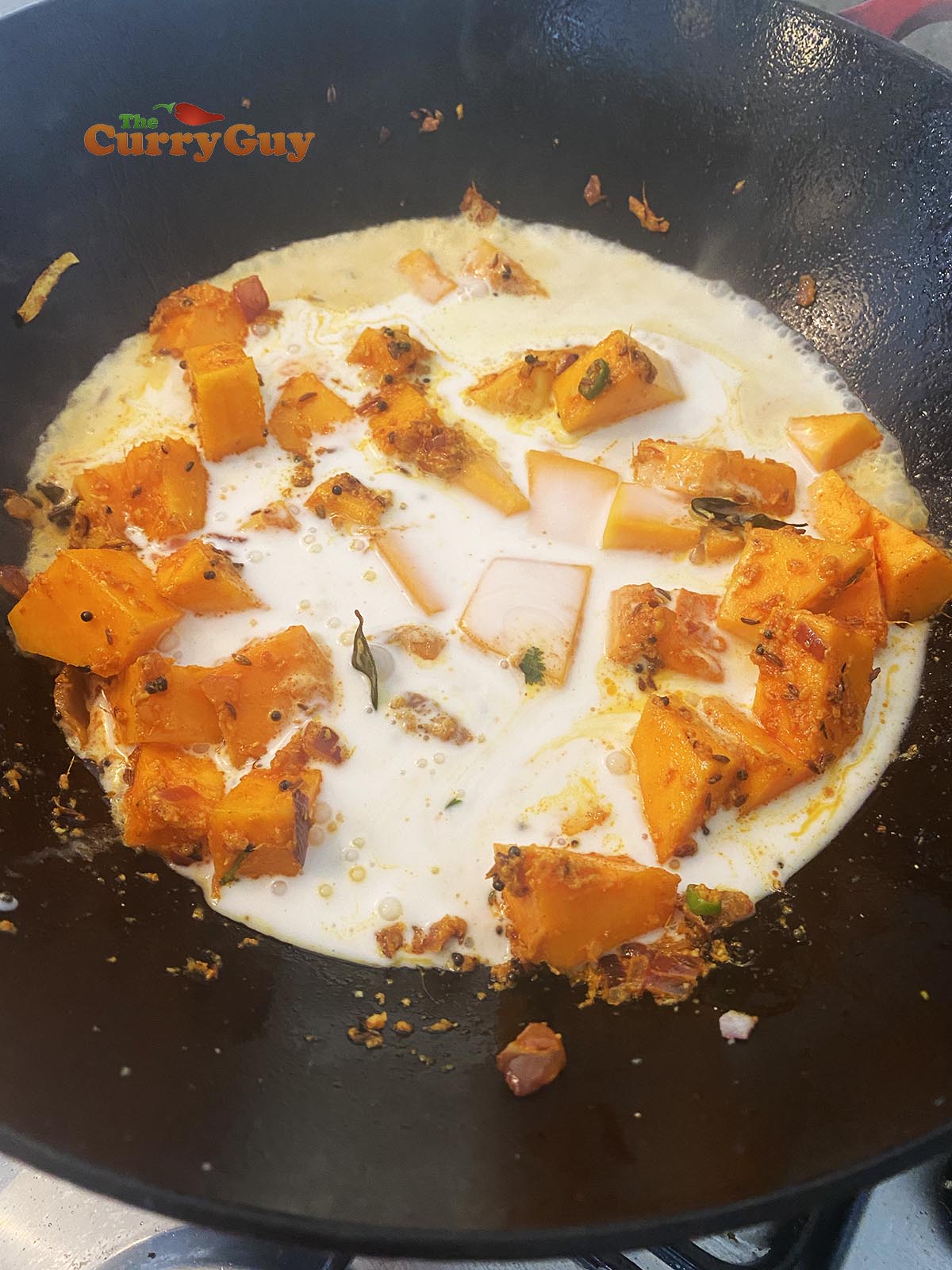 Adding coconut milk to the pan