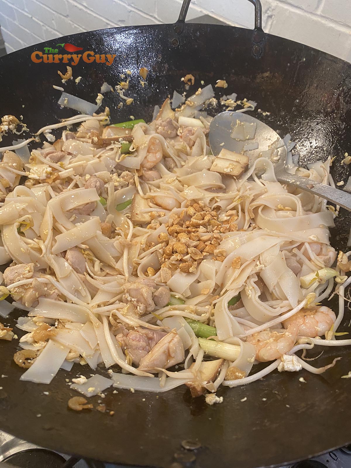 Adding chillies and chopped peanuts.