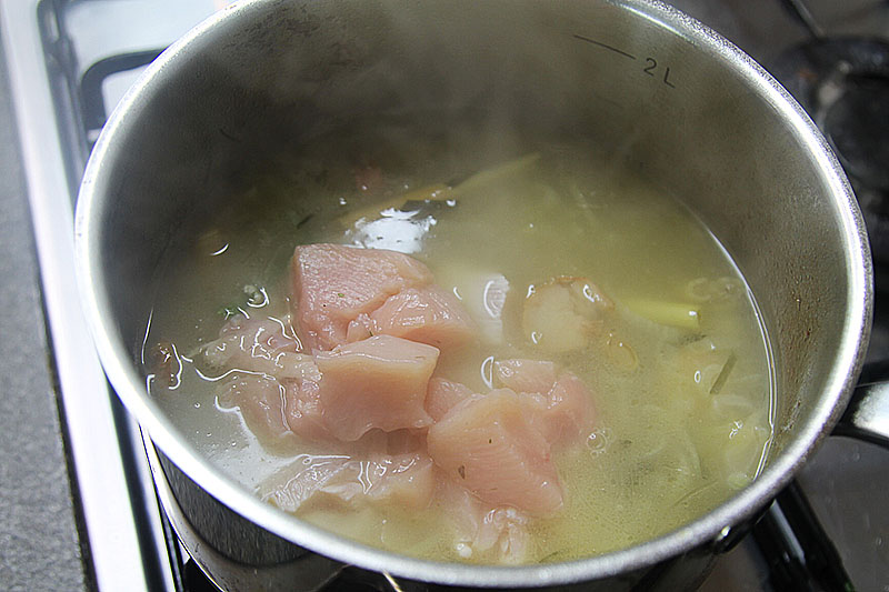 Adding chicken to Thai spicy soup