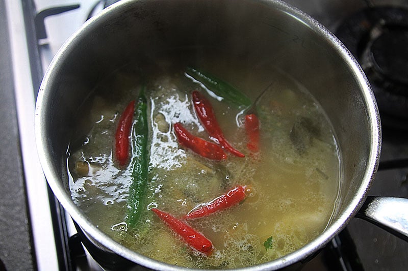 Adding chillies for spiciness in a Thai soup