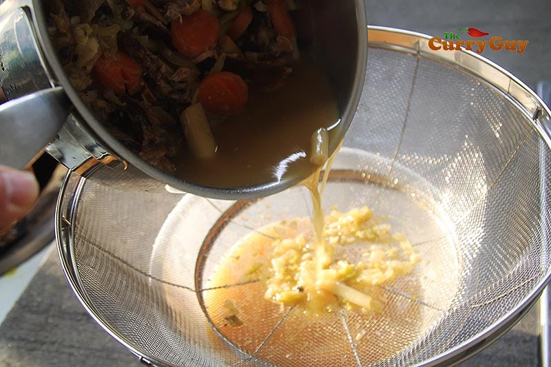 straining pork stock