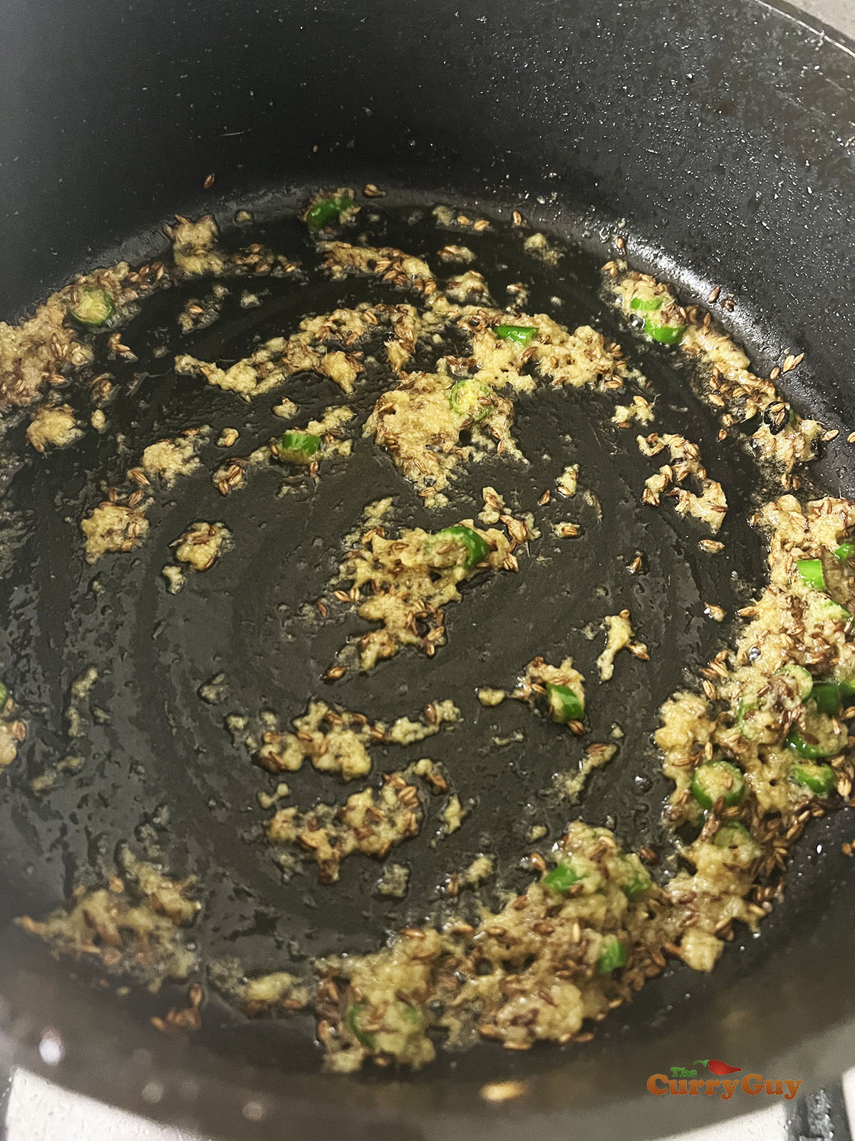 Stirring in the chopped chillies.