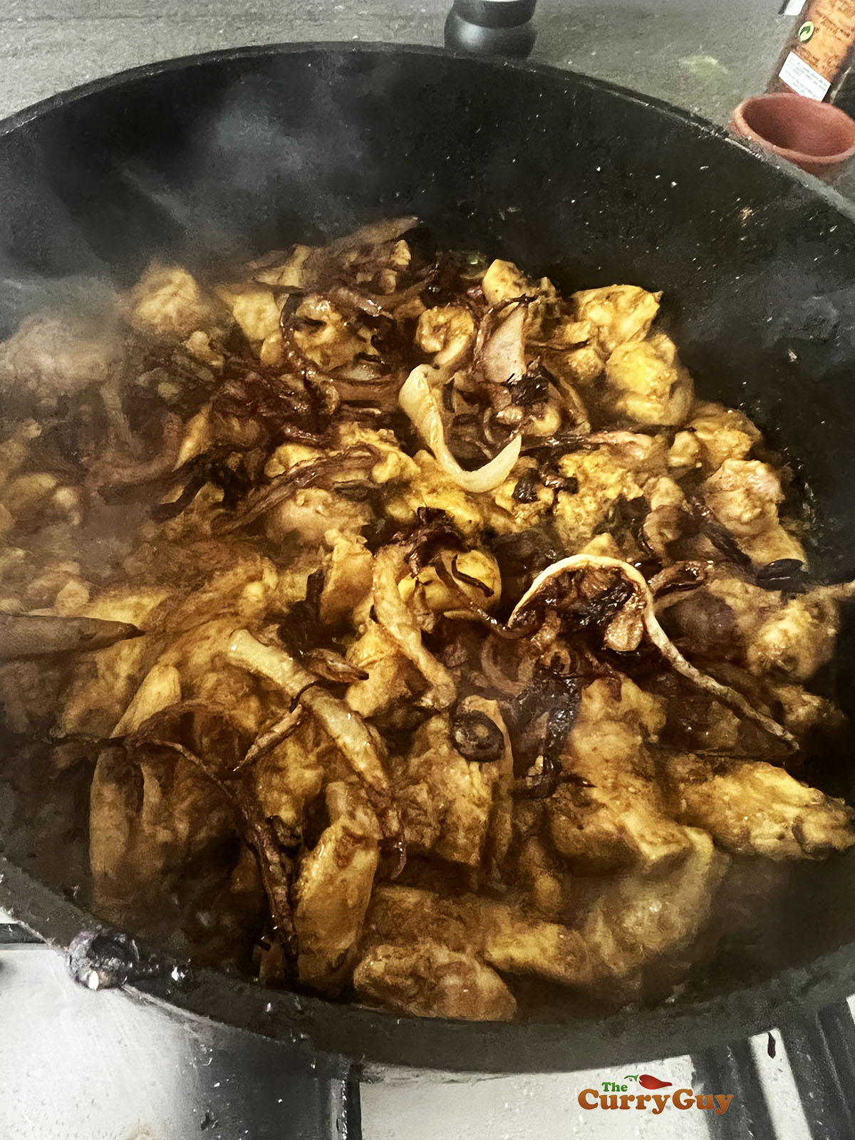 Adding fried onions to the pan.