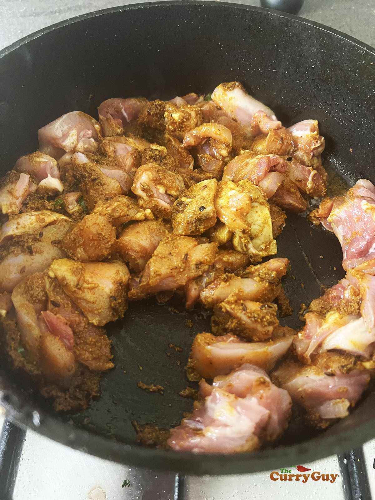 Stirring the chicken into the pan.