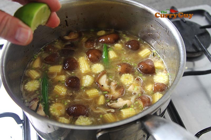Adding lime juice to Thai prawn soup