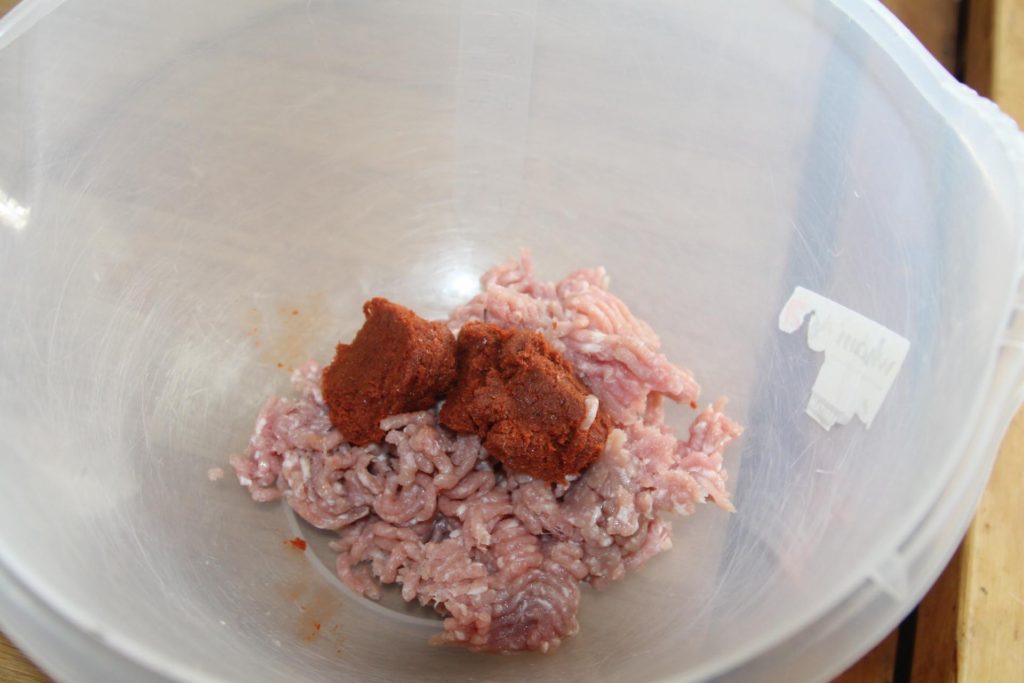 Adding curry paste to meat.