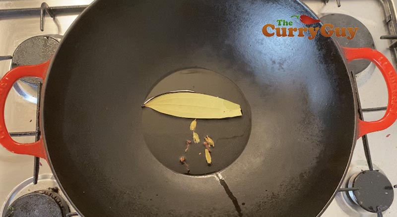 Adding spices and oil to pan