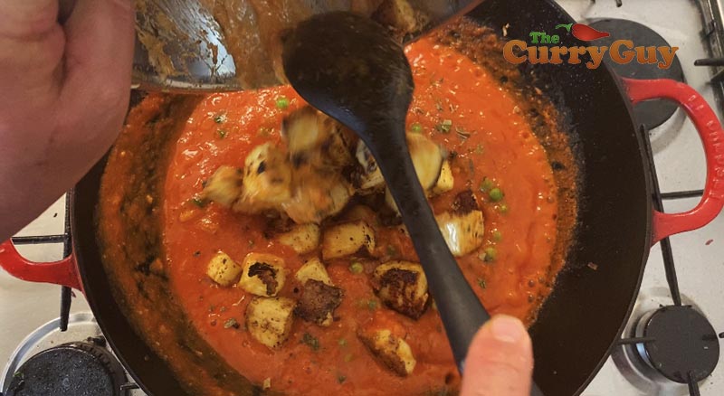 Adding the paneer to muttar paneer sauce.