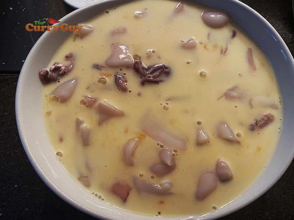 Adding marinated squid to eggs