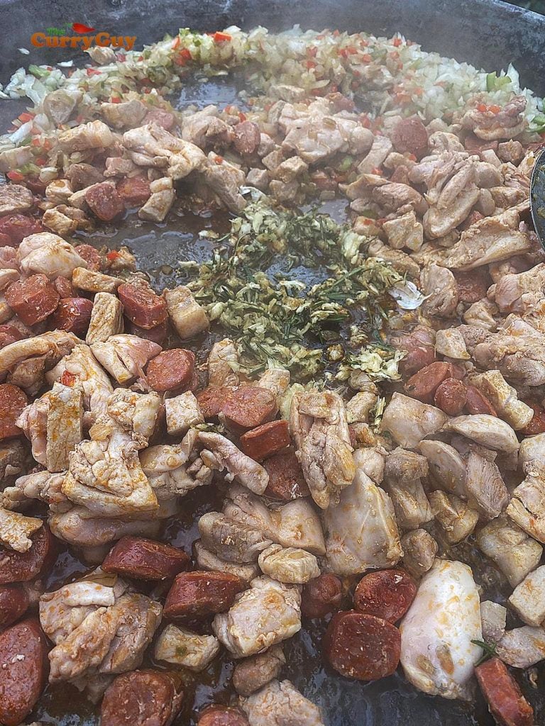 adding garlic to paella